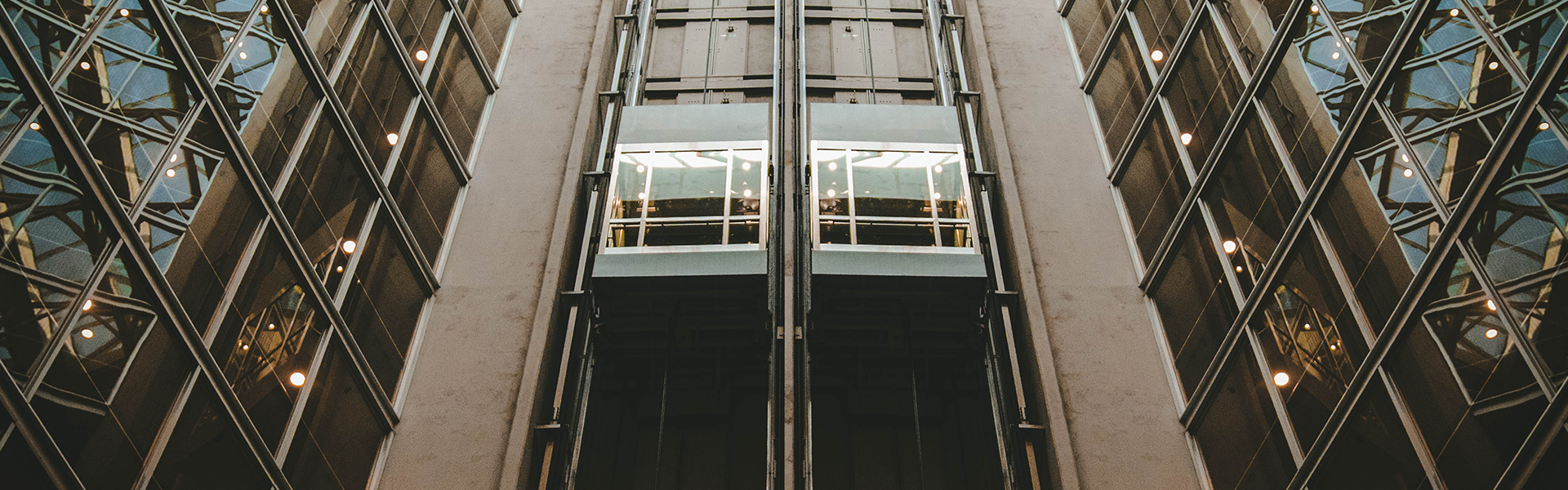 Glass elevator installation in a modern atrium